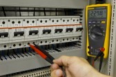 10541480-electrical-engineer-measuring-voltage-on-a-miniature-circuit-breaker.jpg